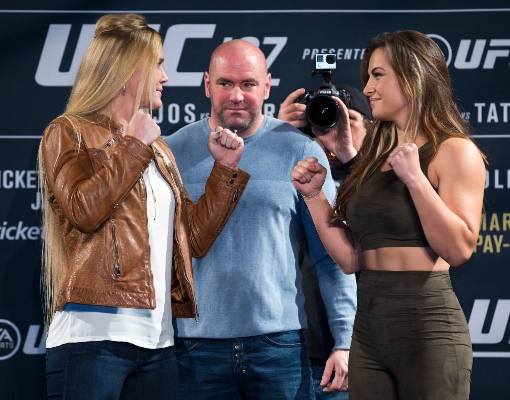 UFC 196 intense face-off Holly Holm vs Miesha Tate with Dana White sharp pre-fight stare-down Wallpaper
