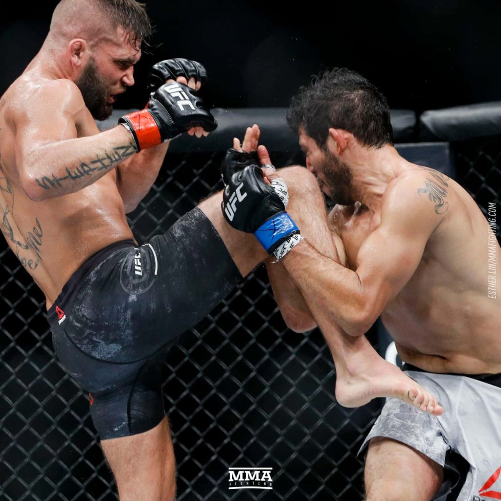 Jeremy Stephens lands a powerful leg kick on Gilbert Melendez in UFC 215 Octagon fight Wallpaper
