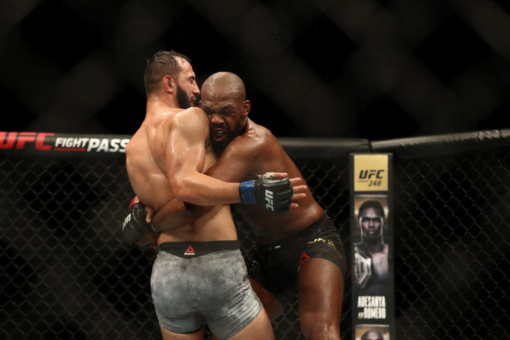 UFC 247 wallpaper of Jon Jones vs Dominick Reyes intense grappling in light heavyweight fight