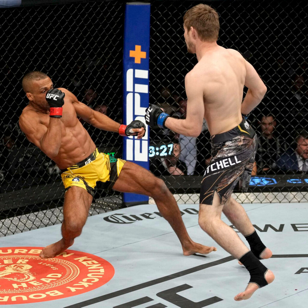 UFC 272 wallpaper featuring Bryce Mitchell and Edson Barboza mid-action intense MMA fight scene