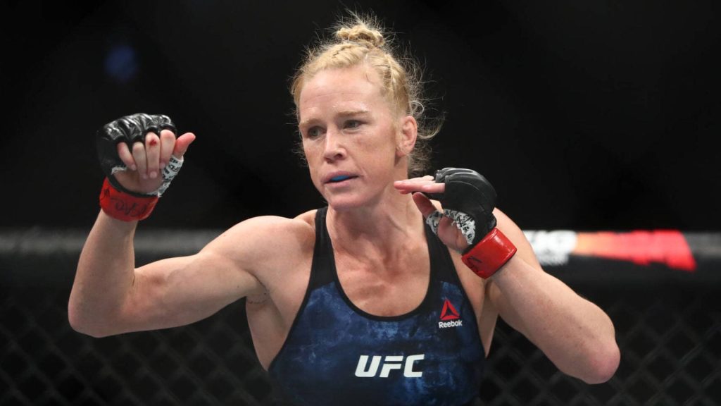 UFC fighter Holly Holm in Reebok gear focused in fight stance inside octagon wallpaper