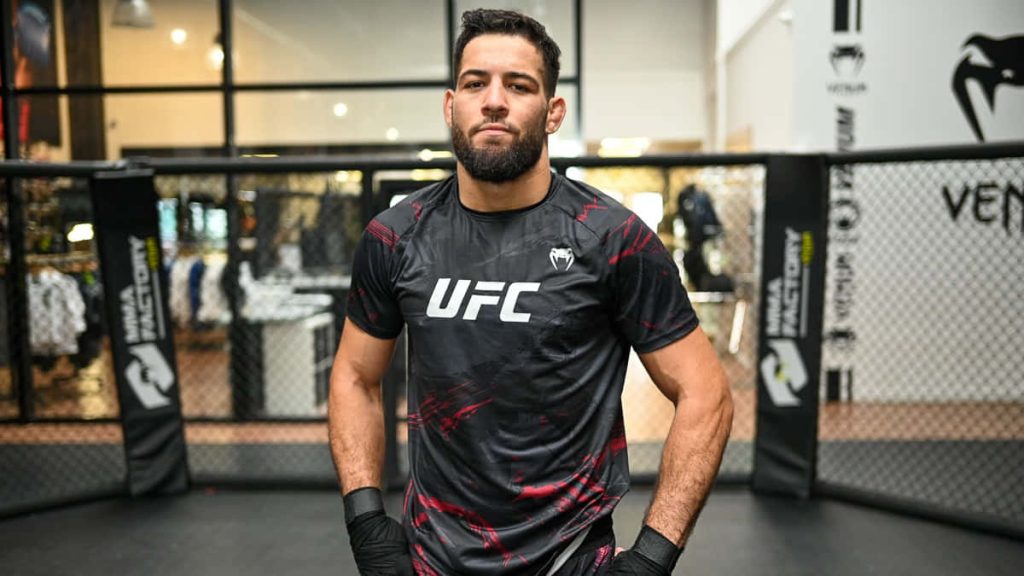 UFC fighter Nassourdine Imavov focused in MMA Factory gym wearing black UFC shirt and hand wraps Wallpaper