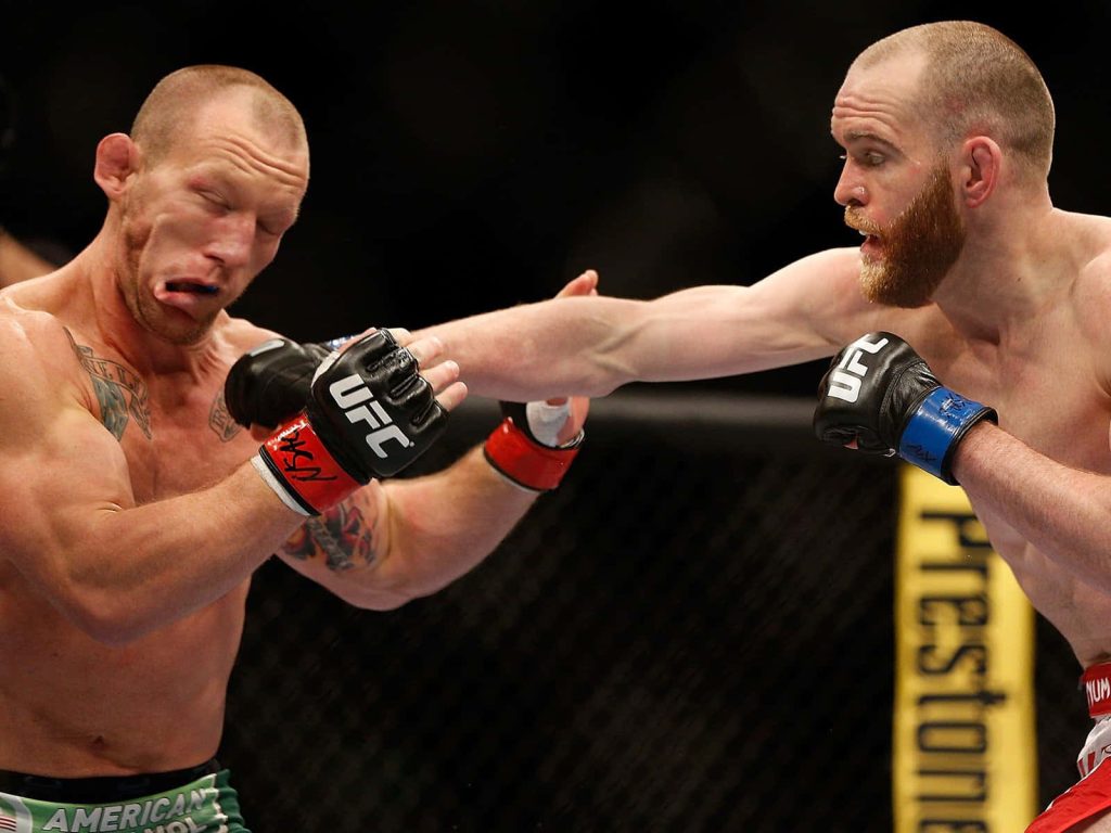 UFC fight action Gray Maynard receives punch from Ross Pearson intense MMA octagon battle Wallpaper