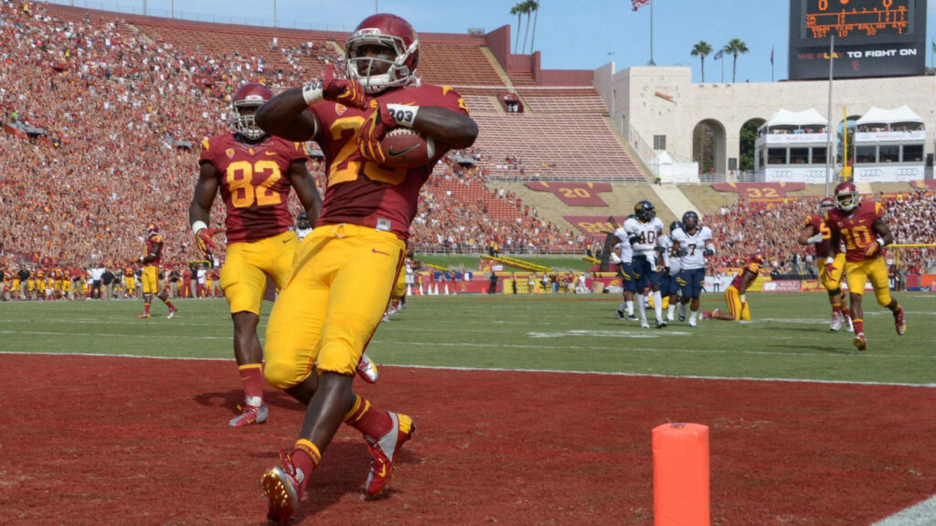 USC Football Player Celebrates Touchdown at LA Coliseum - Wallpaper