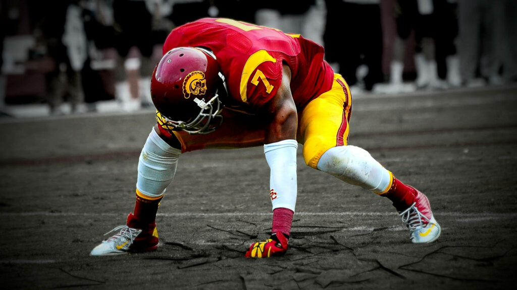 Intense USC Football Wallpaper: Power & Determination in Action