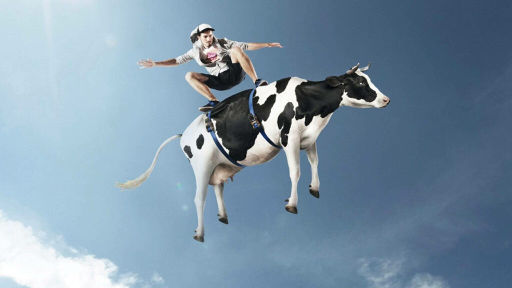 Young skater riding black and white cow through blue sky surreal digital art wallpaper background