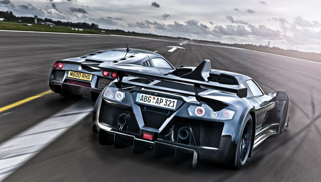 Thundering Speed: Captivating HD Wallpaper of Racing Cars on Track