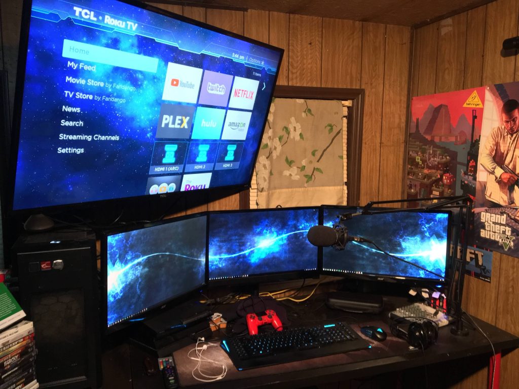 Ultimate gaming room with triple monitors blue glow TCL Roku TV mechanical keyboard GTA V poster Wallpaper