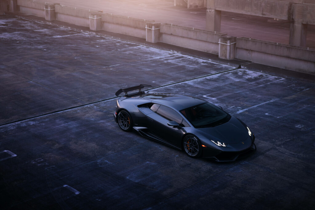 Lamborghini sports car in ultra HD parked on rooftop with sunlight highlighting sleek design Wallpaper