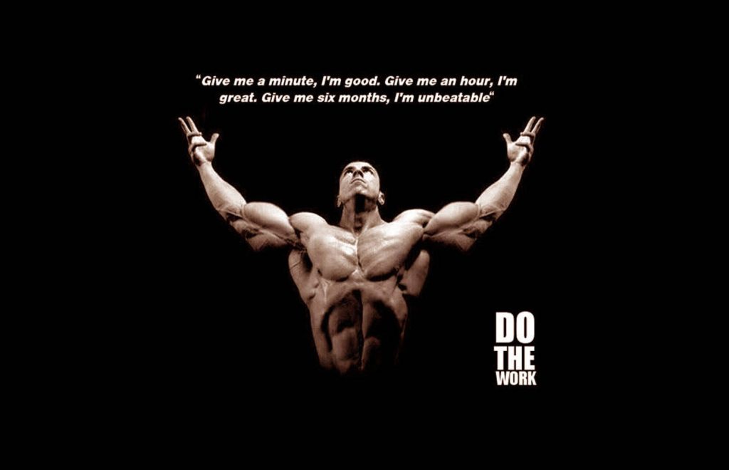 Muscular bodybuilder victory pose fitness wallpaper with motivational quote six months unbeatable