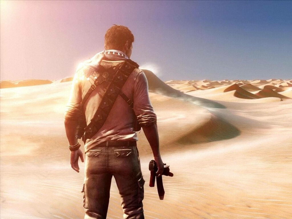 Stunning Uncharted Game Wallpaper: Adventurer in Sunlit Desert Dunes