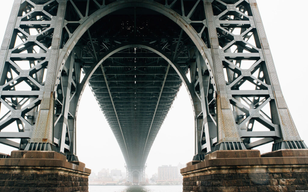 Dramatic view beneath Brooklyn Bridge steel beams geometric patterns urban NYC cityscape background Wallpaper