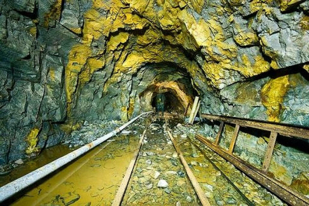Underground Gold Mine Wallpaper: Rugged Industrial Tunnel Design