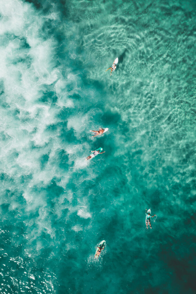 Serene Ocean Bliss: Adventurous Young Surfers Navigating the Vibrant Turquoise Waves at Bondi Beach, Australia Wallpaper