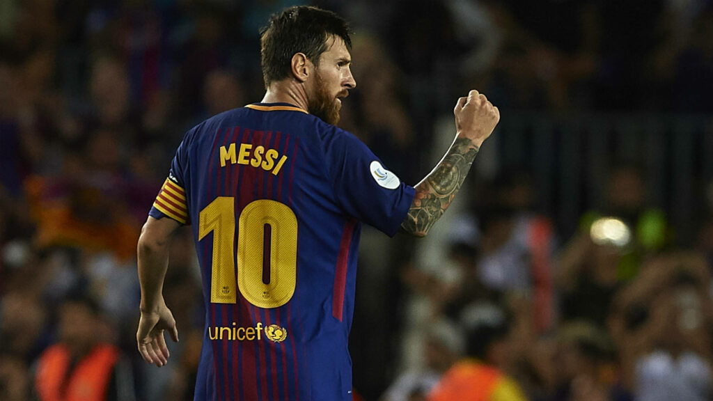 Lionel Messi celebrates in classic Barcelona kit with captain armband and Unicef logo in stadium Wallpaper