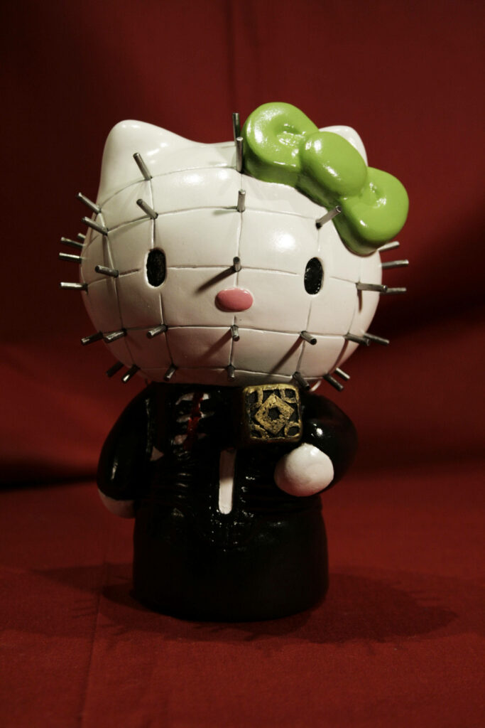 Unique Hello Kitty Halloween Wallpaper: Spiky Face & Green Bow