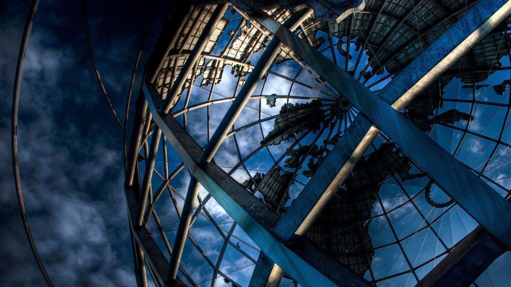 Unisphere metal globe in Flushing Meadows park low angle steel lattice against deep blue sky wallpaper