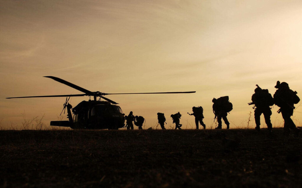 Elite Troops Converging Towards the Waiting Chopper - Captivating Military Wallpaper