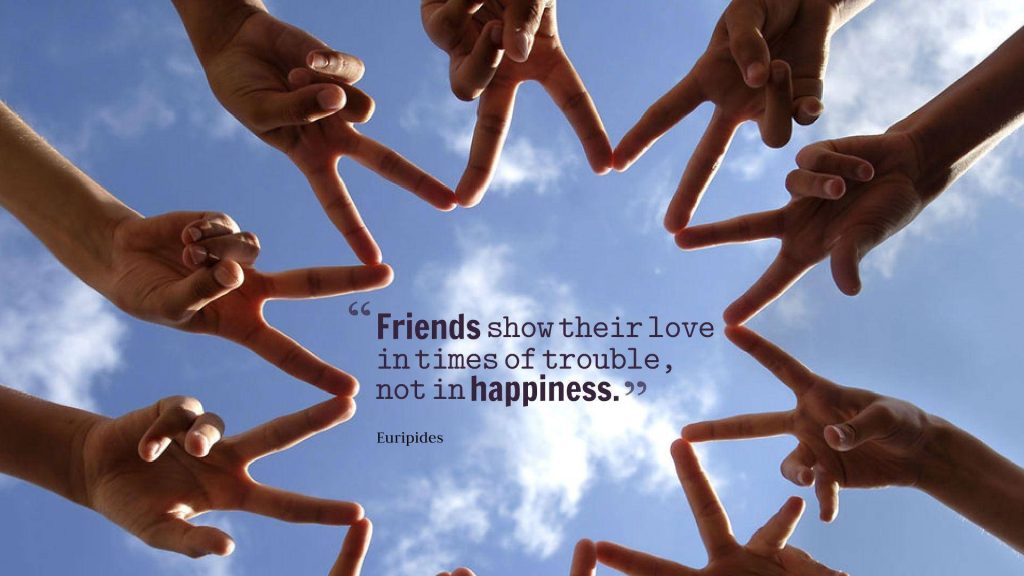 Hands joined in star shape against blue sky symbolizing unity with Euripides friendship quote wallpaper