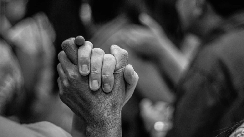 Unity in Diversity: Black and White Hands Clasped Wallpaper
