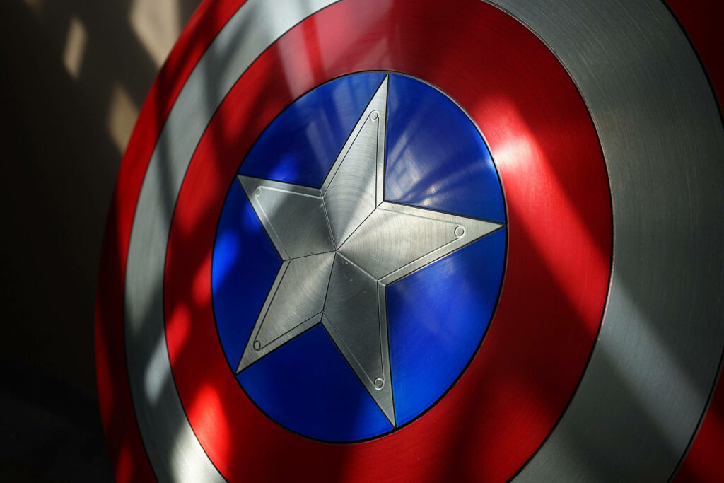 Marvelous Captain America Shield Emblem with Artistic Shadow Wallpaper