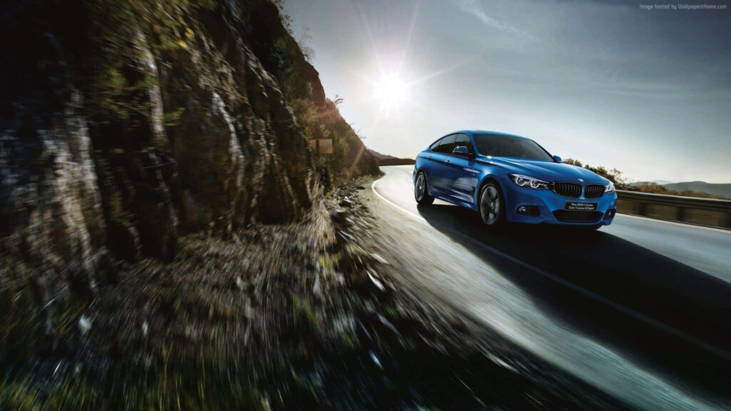Blue BMW Series Car on Road Wallpaper