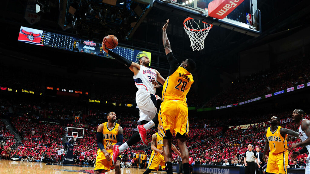 Miami Heat Player Dunks Over Pacers Defender in Intense NBA Game Wallpaper