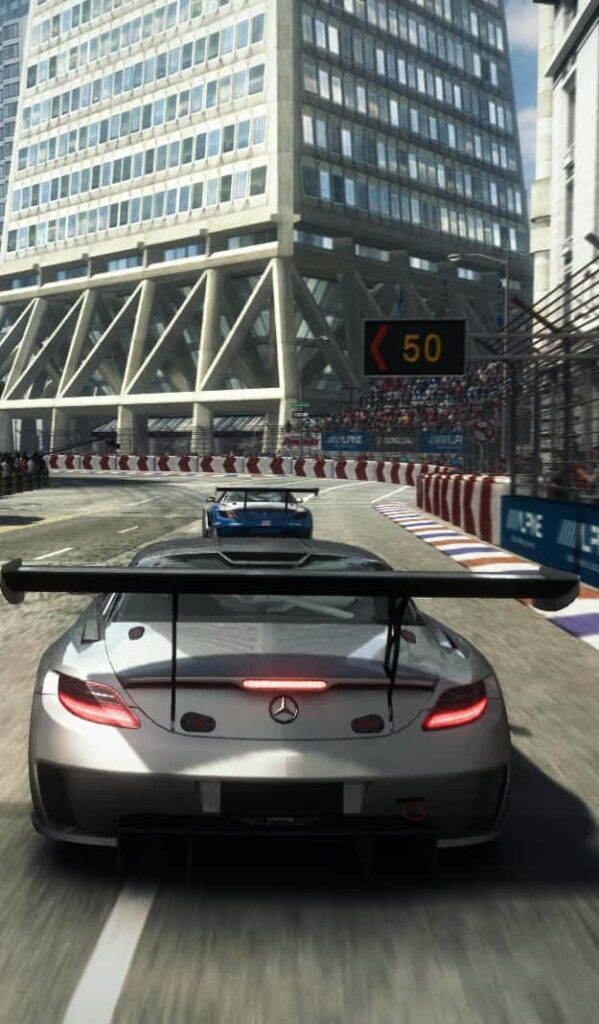 Grid Autosport: Silver sports car speeding through city circuit in high-speed action Wallpaper