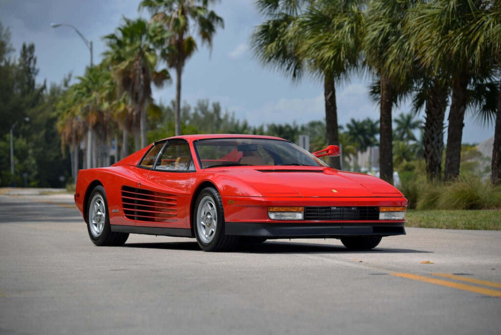 Unleash Your Inner Speedster: Witness the Thrilling Power and Elegance of a Red Ferrari Testarossa, as it Soars Across the Open Road Wallpaper
