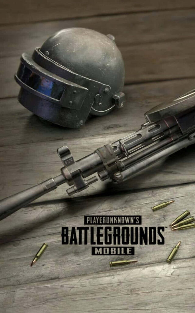 PUBG Mobile Wallpaper: Battle-Worn Helmet and Assault Rifle on Wooden Surface with Scattered Ammunition - Android Background Image