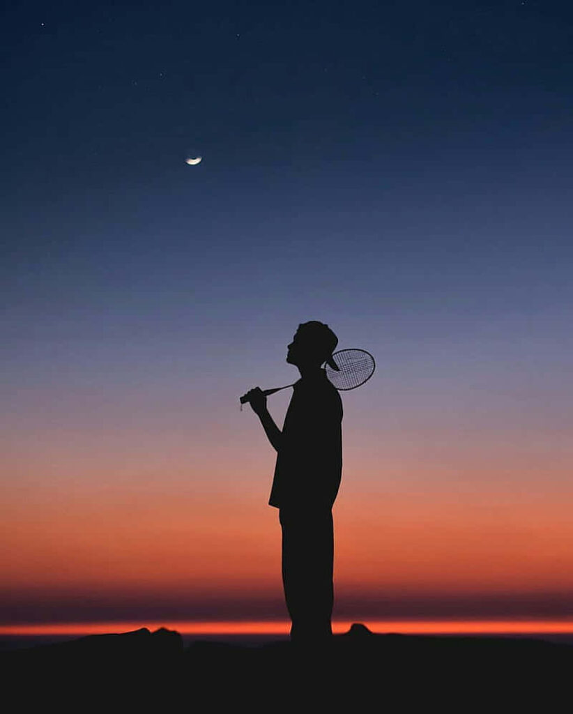 Badminton Player Silhouette and Sunset Background Wallpaper