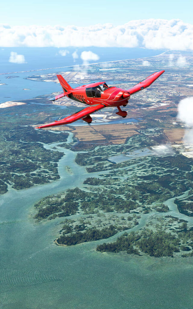 Microsoft Flight Simulator: Stunning Red Aircraft Soaring Over Detailed Landscape - Aviation Enthusiasts' Wallpaper