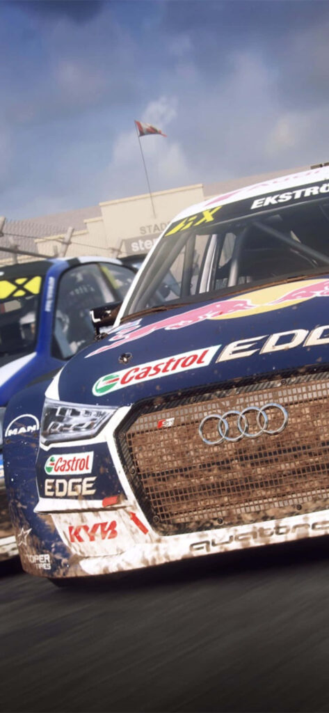 High-Energy Dirt Rally Car Wallpaper with Sponsor Decals