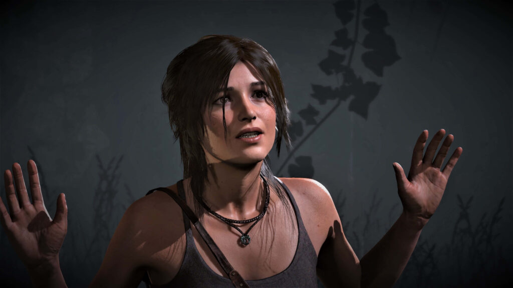Shadow of the Tomb Raider Lara Croft high-res wallpaper showing adventurer in defensive stance, dimly lit backdrop with shadow cast - photo