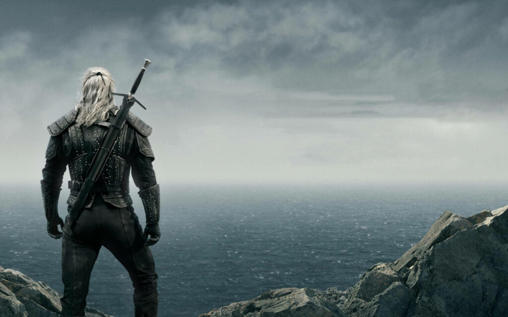 The Witcher's Geralt Strides into Battle: Henry Cavill Backshot Wallpaper