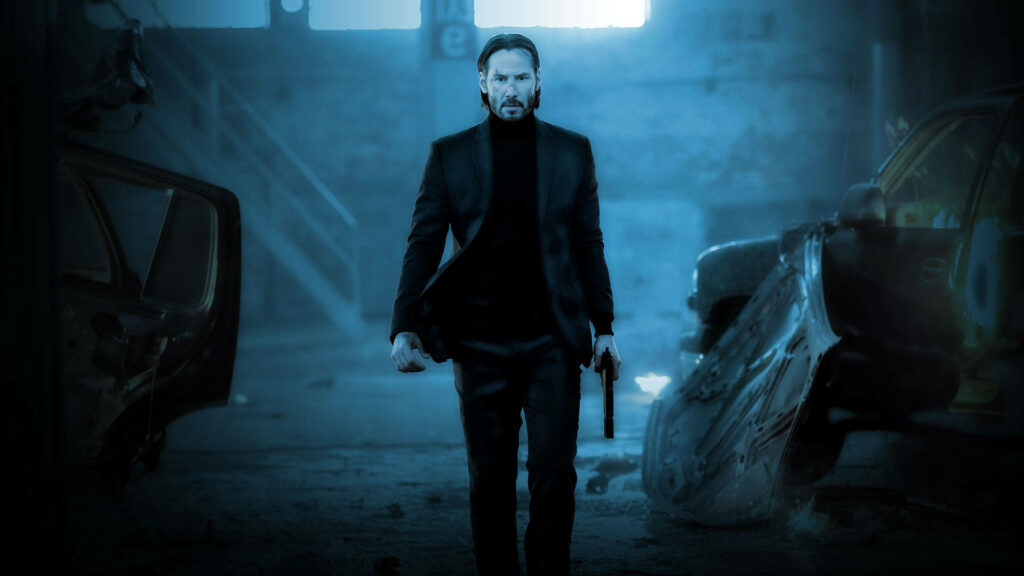 The Heroic Stare of John Wick: Exuding Justice in Navy Blue Wallpaper