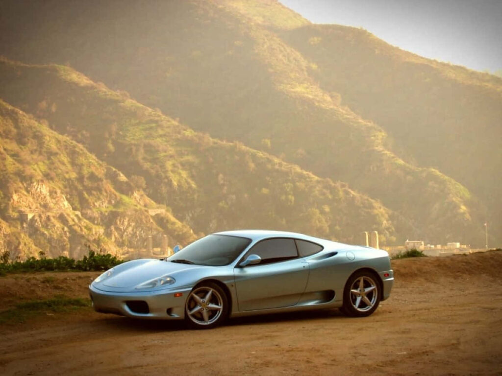 Blue Ferrari 360 Modena Against a Mountain View Background Wallpaper