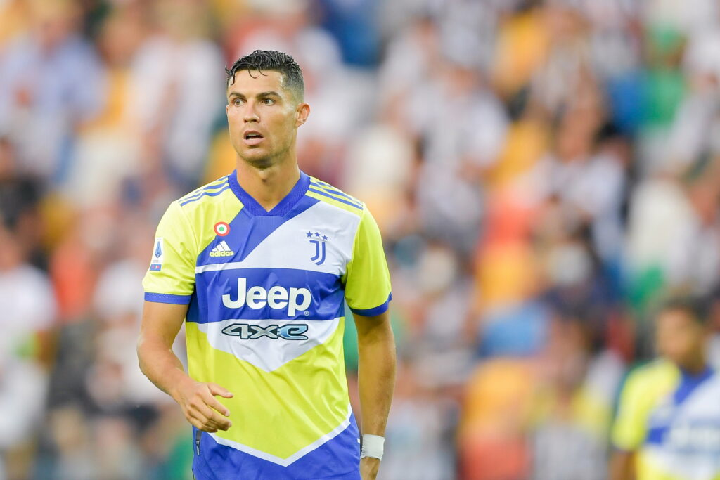 The Phenomenon in Stripes: Cristiano Ronaldo Dominating in Juventus FC's QHD Wallpaper Background
