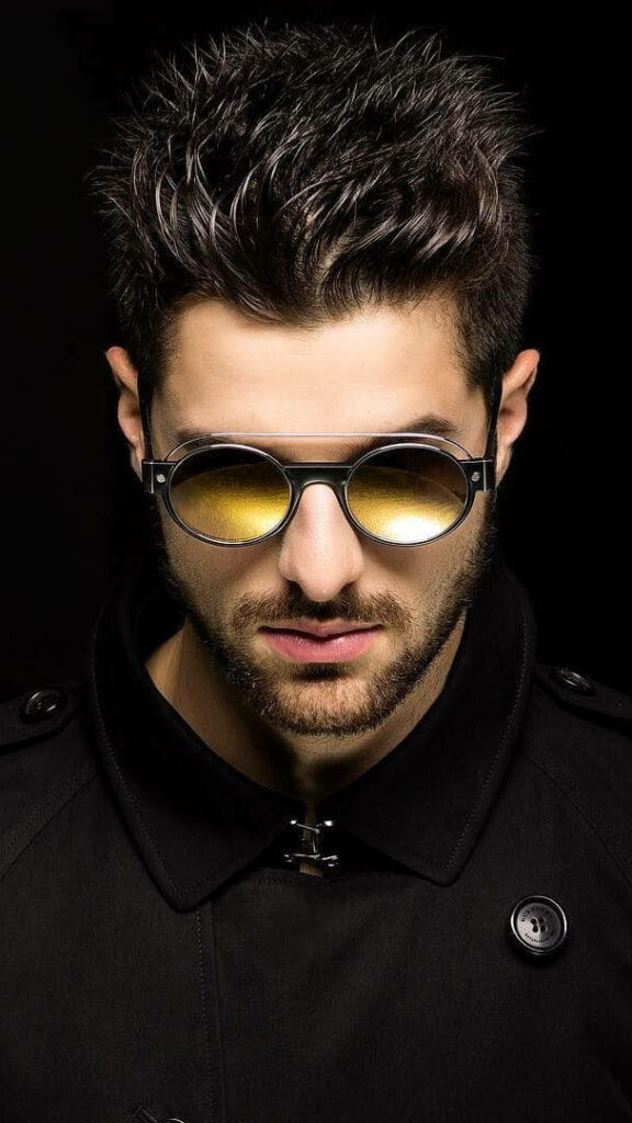 Electrifying Style: Dj Alok Free Fire Game Character Shining Against a Dark Canvas Wallpaper