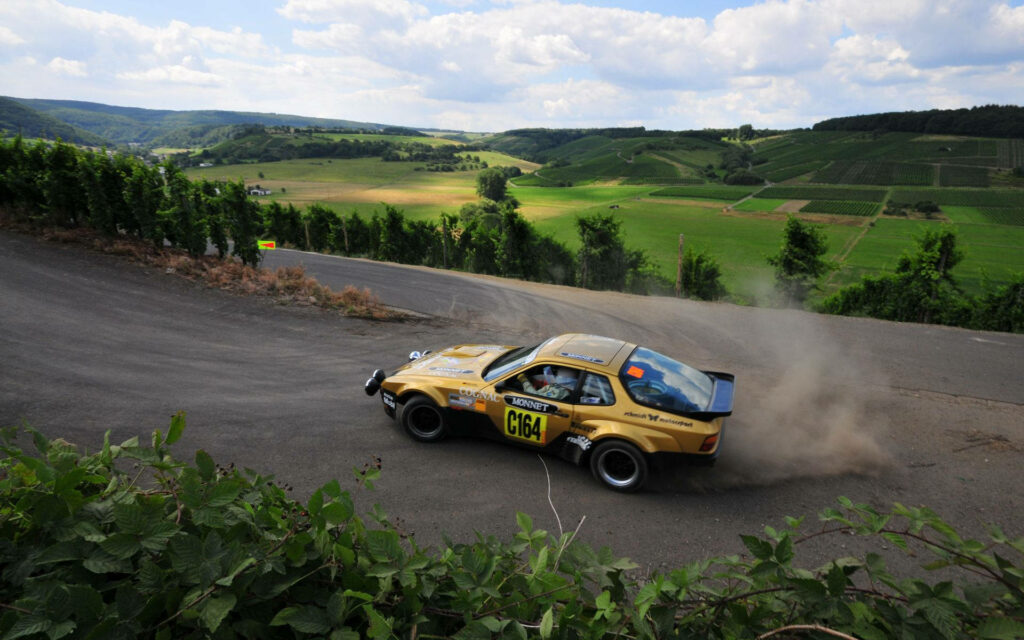 Vintage Porsche 944 Capturing Thrilling Drift Up an Inclined Road - Nostalgic Classic Car Photo Wallpaper