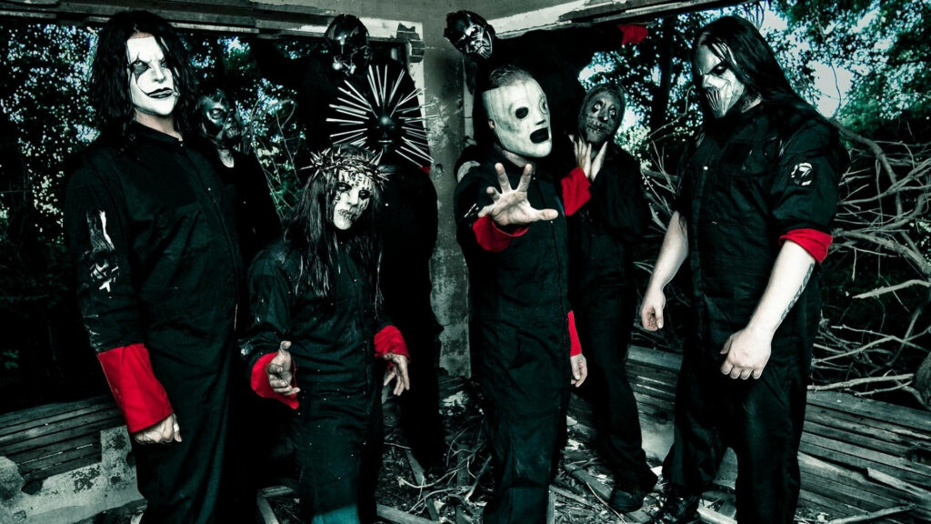 The Men Behind the Masks: Slipknot's Full Outfit Posing in an Impressive Wallpaper