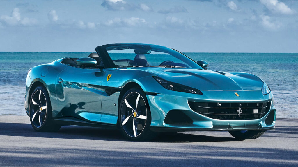 Blue Ferrari Portofino Near a Blue Ocean Background Wallpaper