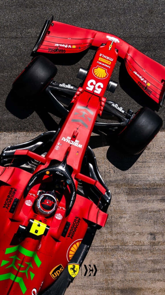 Unmistakable Speed: Classic Red Scuderia Ferrari F1 Race Car Dominating the Racetrack Wallpaper