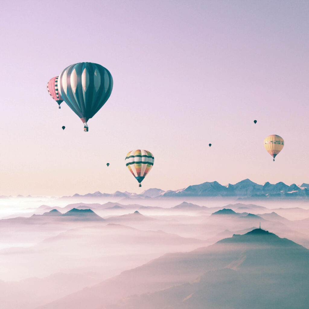 Skyward Journey: Charming Hot Air Balloons Soaring Through Clouds – Delightful Ipad Background Wallpaper