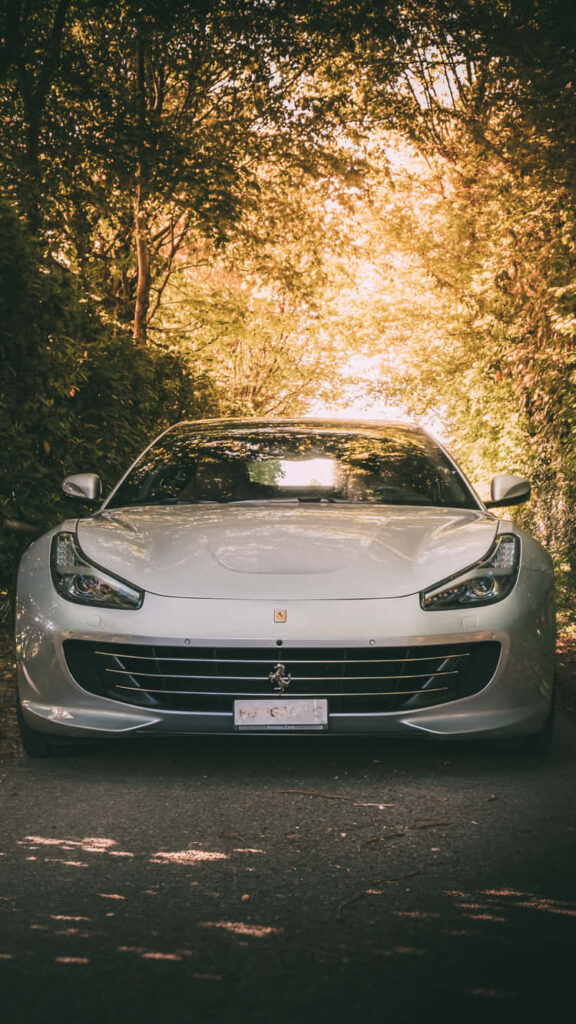 Experience Elegance in Motion with the Iconic White Ferrari iPhone Wallpaper