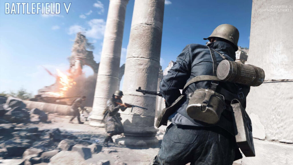 Intense Action Scene from Battlefield V Video Game - Soldiers in WWII Uniforms Running Through Battlefield with Explosion in Background Wallpaper