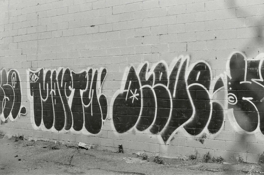 Edgy Black and White Graffiti Wallpaper: Bold Urban Art Background