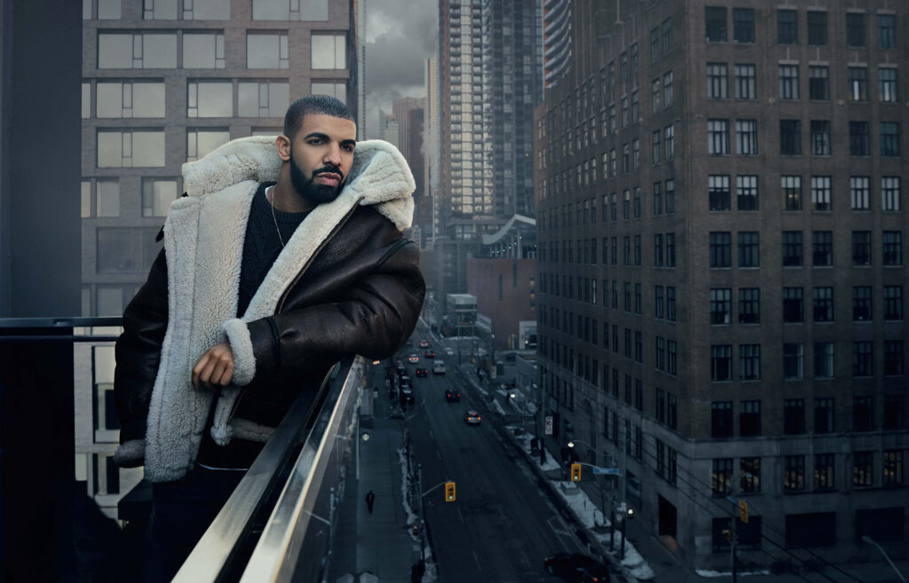 Urban Balcony Wallpaper: Drake in Stylish Shearling Coat