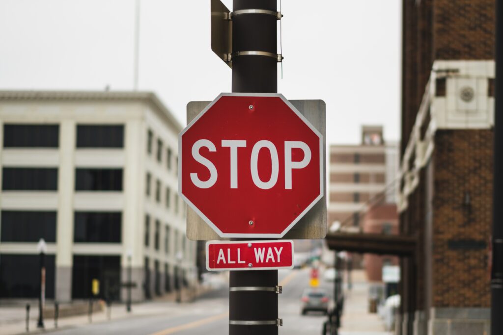 Urban Cityscape Wallpaper: Red STOP Sign & ALL WAY Inscription