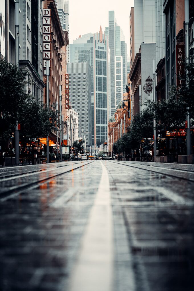 Vibrant Urban Cityscape Wallpaper: Skyscrapers & Wet Streets